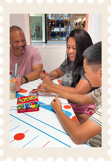 Guests sharing a game of UNO at Boba Nation Grand