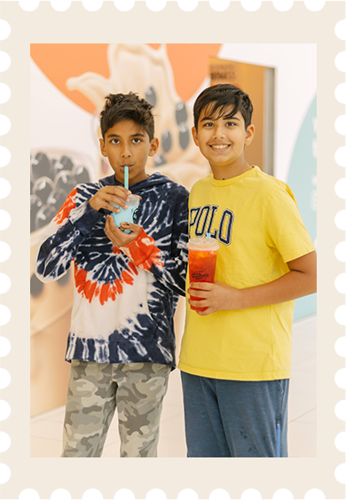 Two friends enjoying their Boba Nation drinks