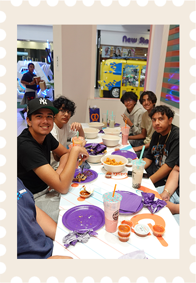 A group sharing drinks and a meal at Boba Nation Grand
